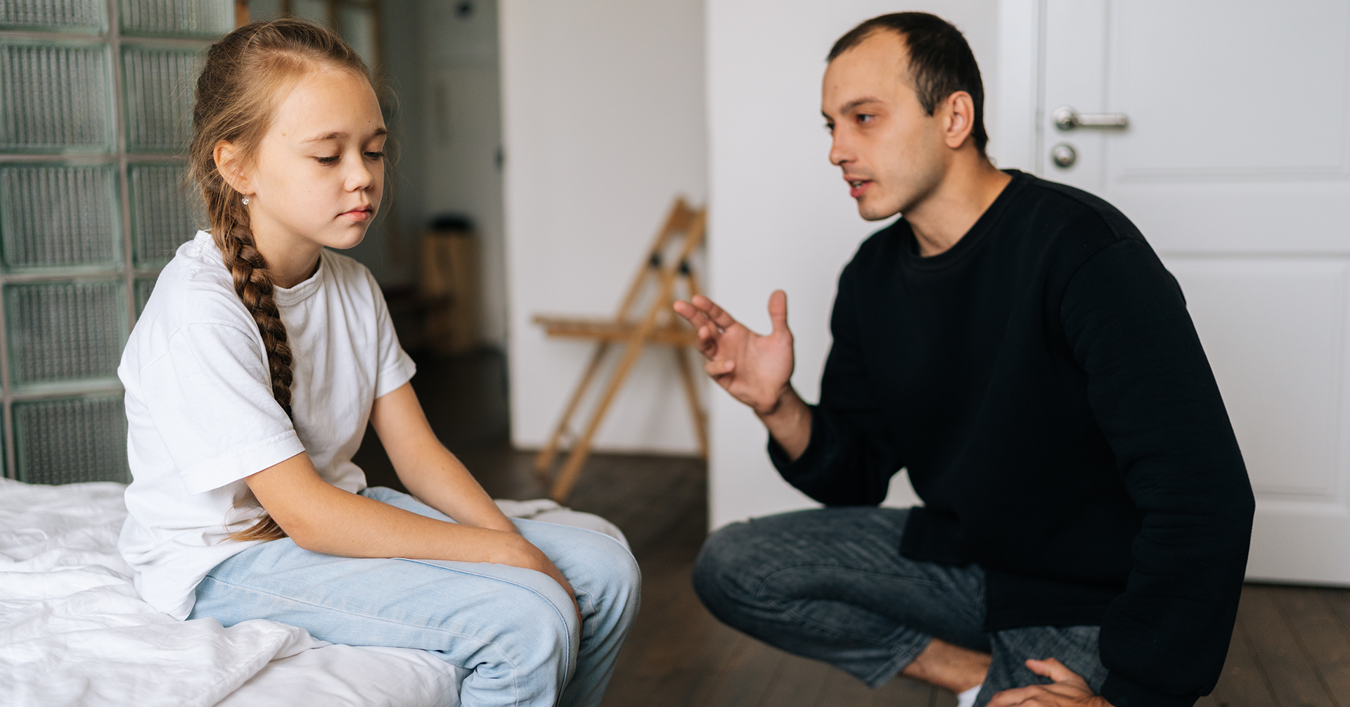 concerned parent talking to worried child about divorce