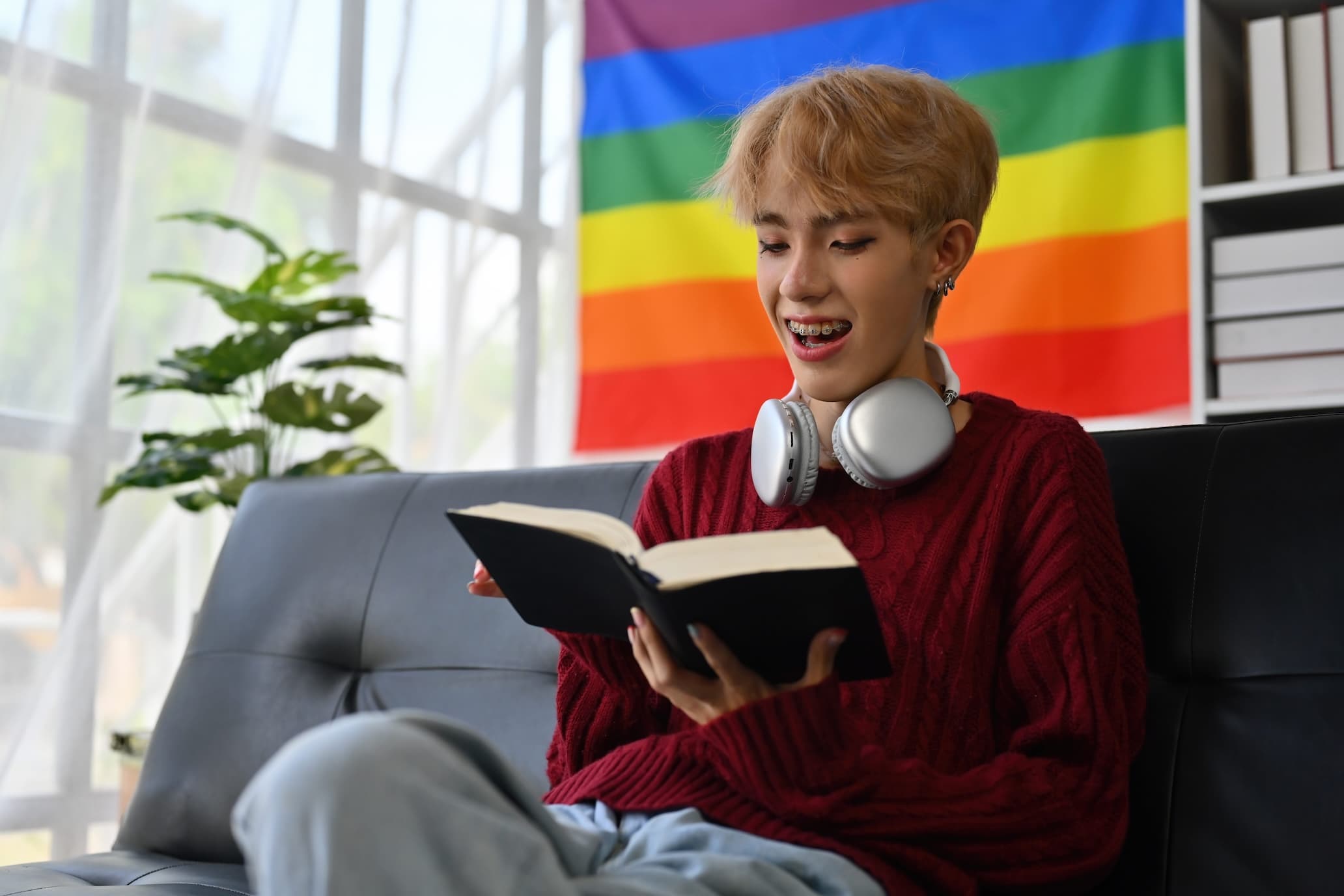 Child reading book on couch