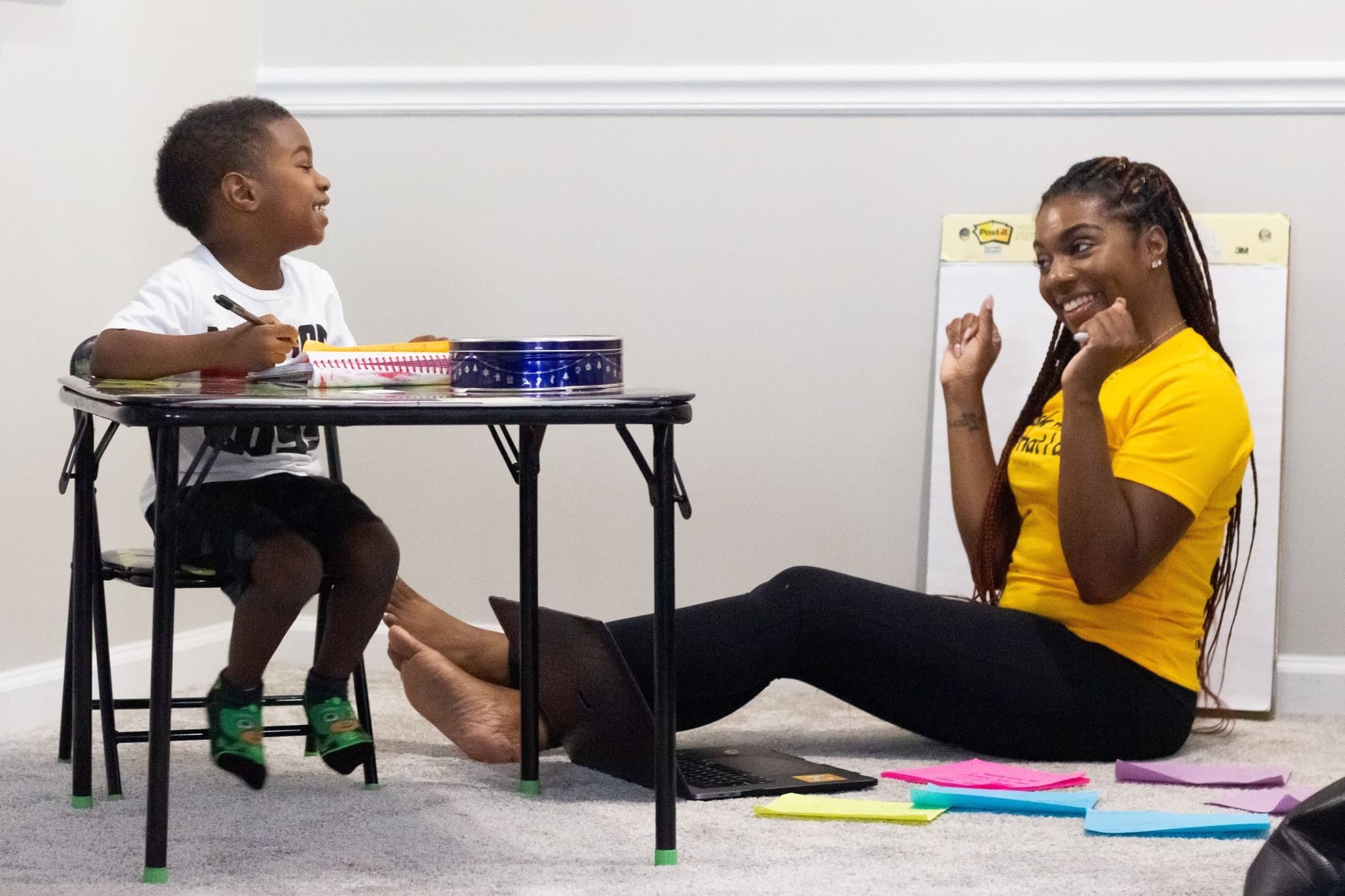 Adult teaching child at table how to be kind